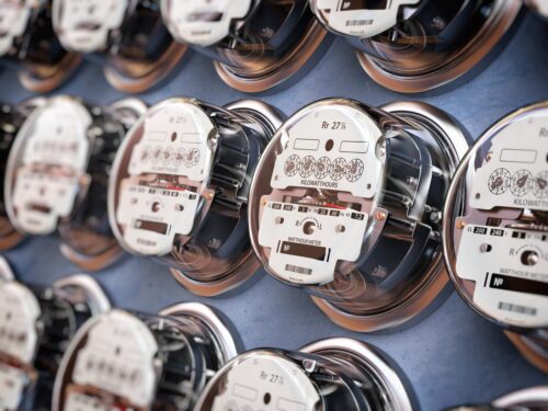Multiple rows of electric meters on a utility panel. Getty Images.